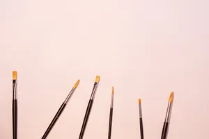 A variety of paintbrushes in different sizes against a clean white background, perfect for artistic themes. jigsaw puzzle