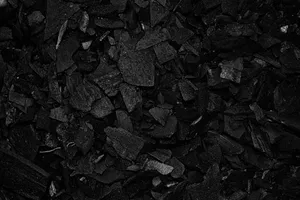 Detailed view of black charcoal pieces arranged in a pile for grilling or art use. jigsaw puzzle