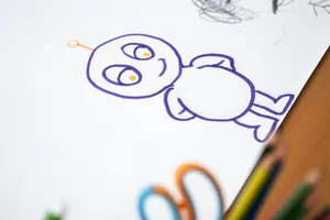 Colorful cartoon character sketch on paper with colored pencils on the side. jigsaw puzzle