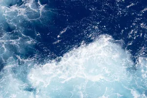 Dynamic aerial view of deep blue ocean waves and frothy seafoam patterns. jigsaw puzzle