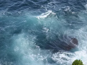 Dynamic ocean waves crashing against rocks in a powerful seascape aerial shot. jigsaw puzzle