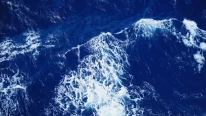 Aerial view of vibrant ocean waves crashing with dynamic white foam. jigsaw puzzle