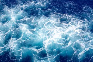 Captivating ocean waves with frothy white foam and deep blue hues creating a mesmerizing texture. jigsaw puzzle