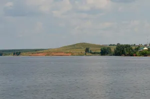 a body of water with trees and hills in the background jigsaw puzzle
