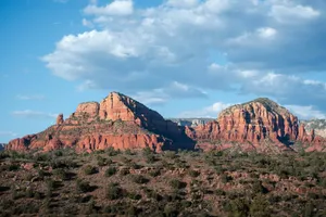 A view of a mountain range with clouds in the sky jigsaw puzzle