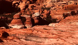 A red rock formation with a mountain in the background jigsaw puzzle