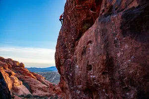 a man climbing up the side of a mountain jigsaw puzzle