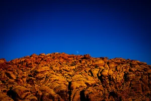 the moon is setting over a rocky mountain jigsaw puzzle