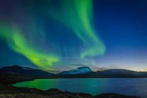 aurora borealis over body of water during nighttime jigsaw puzzle