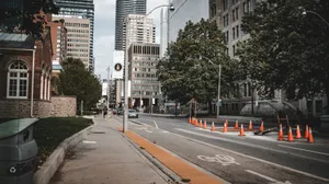 a city street with traffic cones on the side of the road jigsaw puzzle