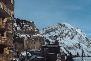 a snow covered mountain in the background with buildings in the foreground jigsaw puzzle
