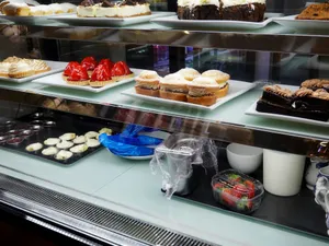Assortment of pastries and desserts in a display case. jigsaw puzzle