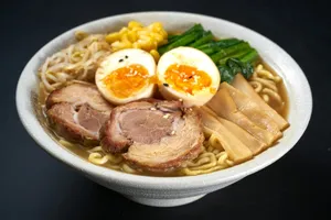 a bowl of ramen with meat, eggs, noodles and vegetables jigsaw puzzle