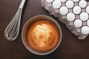baked muffins beside tray of eggs and whisker jigsaw puzzle
