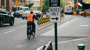 man riding bicycle on street near cars jigsaw puzzle