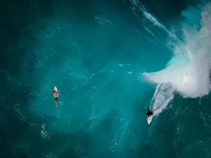 aerial photography of two persons surfing jigsaw puzzle