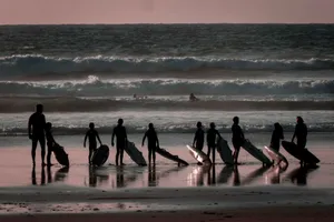 person holding surfboards jigsaw puzzle