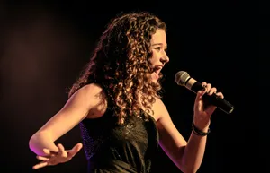 woman in black sleeveless dress singing jigsaw puzzle