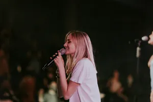 woman in white t-shirt singing jigsaw puzzle