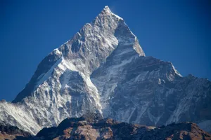 Stunning view of Machhapuchchhre mountain peak in Nepal's Himalayas under blue skies. jigsaw puzzle