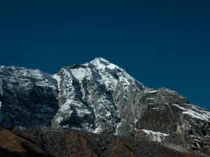 Majestic snow-covered Himalayan peak against a deep blue sky in daylight. jigsaw puzzle