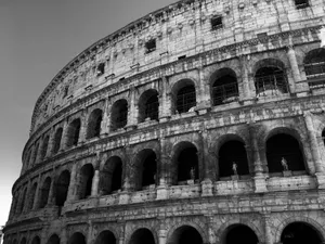 Low angle black and white view of the historic Colosseum in Rome, showcasing its ancient architectural grandeur. jigsaw puzzle