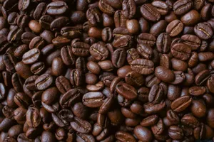 Closeup of aromatic roasted coffee beans showcasing rich textures and deep brown hues. jigsaw puzzle