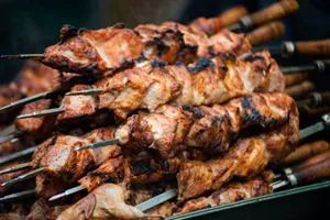 Juicy grilled shashlik skewers stacked outdoors, showcasing vibrant barbeque textures in Moldova. jigsaw puzzle