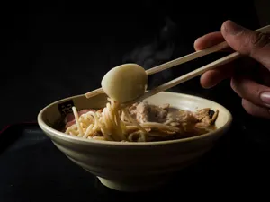 Close-up of authentic ramen noodles with boiled egg and chopsticks. Perfect for food enthusiasts. jigsaw puzzle