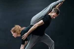 A male and female dancer in a dynamic pose during a rehearsal, showcasing strength and flexibility. jigsaw puzzle