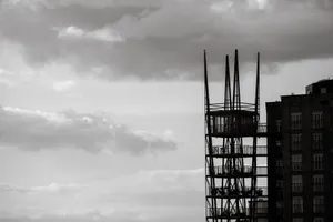 Silhouette of a steel structure tower against a cloudy sky in the city. jigsaw puzzle