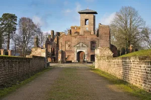 Explore the ruins of an old brick castle, a historic landmark surrounded by winter foliage. jigsaw puzzle