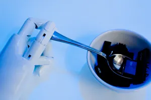 A robotic hand holding a spoon above a bowl with keyboard keys, showcasing technology themes. jigsaw puzzle