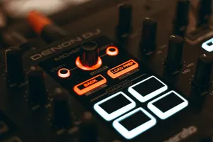 A detailed close-up of a DJ audio mixer with illuminated LED buttons and knobs. jigsaw puzzle