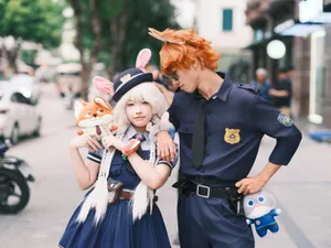 Cosplay couple dressed as animal characters from a popular Disney movie, posing outdoors with plush toys. jigsaw puzzle