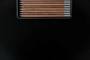 Set of wooden pencils on black background with ample copy space for text. jigsaw puzzle