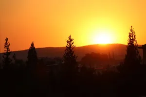 Stunning sunset over the hills of Gaziantep, Turkey with dark tree silhouettes. jigsaw puzzle