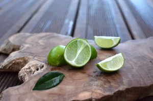 Close-up of fresh sliced limes on a rustic wooden board, ideal for food photography. jigsaw puzzle