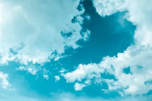 A vibrant scene of cumulus clouds floating in a bright blue sky, creating a serene and dreamy atmosphere. jigsaw puzzle