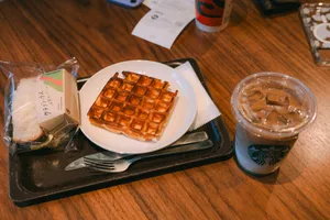 Waffle with iced coffee and sandwich on tray jigsaw puzzle