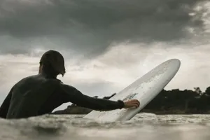 man swimming with surfboard jigsaw puzzle