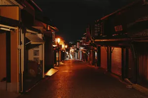 A narrow street at night with buildings lit up jigsaw puzzle