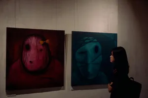 A woman standing in front of three paintings on a wall jigsaw puzzle
