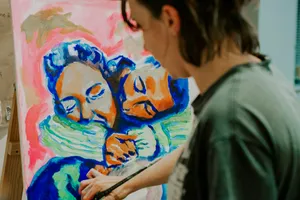 a woman is painting a picture on a canvas jigsaw puzzle