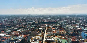 Stunning aerial cityscape of Mexico City under clear blue skies showcasing urban architecture. jigsaw puzzle